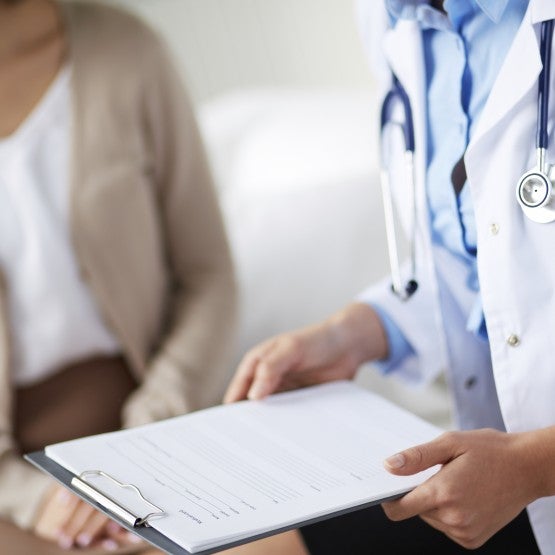 A doctor holding a clipboard