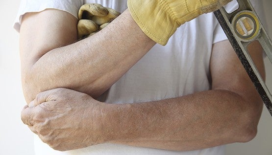 A person holding their arms together with a measure in hand
