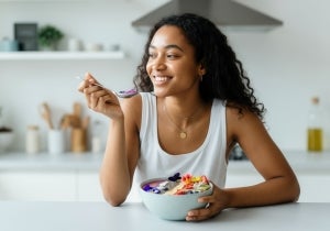 Woman eating healthy bowl of food